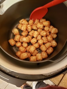 Gently stir the tater tots between cooking cycles to ensure they all get the same amount of hot air.